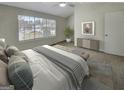 Main bedroom with carpeting, large window, and ceiling fan at 6235 Marbut Farms Trl, Lithonia, GA 30058