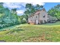 House with a large backyard and trees at 212 Sims St, Palmetto, GA 30268
