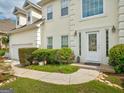 Well-maintained two story home features a two-car garage, manicured shrubs and a walkway at 2560 Almont Way, Roswell, GA 30076