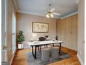 Cozy office with hardwood floors, built-in storage, a ceiling fan, and natural light at 2560 Almont Way, Roswell, GA 30076