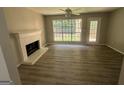 Living room with fireplace and vinyl flooring, and access to backyard at 435 Ridgedale Way, Lawrenceville, GA 30044
