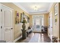 Bright entryway with tile floor, bench, and coat rack at 348 Relative Trl, Mcdonough, GA 30253