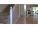 Open living room featuring beautiful hardwood floors and a staircase leading to the upper level at 2884 Mountbery Dr, Snellville, GA 30039