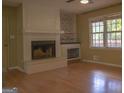 Living room showcasing a fireplace, built-in shelves, and a window at 2884 Mountbery Dr, Snellville, GA 30039
