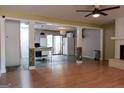 Open-concept living room with hardwood floors, fireplace, and kitchen access at 2884 Mountbery Dr, Snellville, GA 30039
