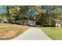 House with long driveway and tree-lined street at 164 Glenloch Pkwy, Stockbridge, GA 30281