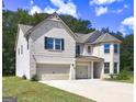 Charming two-story home showcases a three-car garage and an inviting driveway at 161 Jodi Pl, Locust Grove, GA 30248