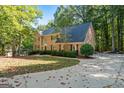 Stately brick home with black shutters, complemented by lush green landscaping and a spacious driveway at 270 Emerald Lake Dr, Fayetteville, GA 30215