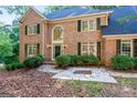 Charming two-story brick home with a grand arched window above the entryway and lush landscaping at 270 Emerald Lake Dr, Fayetteville, GA 30215