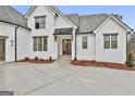 Front entrance of a white farmhouse with a brick walkway at 150 Dockside Dr # 382, Fayetteville, GA 30215