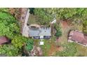 Aerial view of a home with a gray roof surrounded by green trees and a well-maintained yard at 470 Dix Lee On Dr, Fayetteville, GA 30214