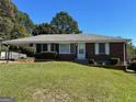 Well-maintained single-story home featuring a classic brick facade and inviting, covered entrance at 2704 Gresham Se Rd, Atlanta, GA 30316