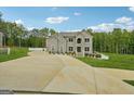 Expansive driveway leading to a distinguished brick home with meticulously maintained landscaping at 3140 Jackson Creek Dr, Stockbridge, GA 30281