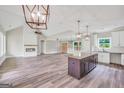 Spacious living room features a modern fireplace, ceiling fan, and an island at 585 Highway 155 North N, Mcdonough, GA 30252