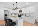 Contemporary kitchen with granite countertops, stainless steel appliances, and a breakfast bar at 1928 Wildwood Dr, Decatur, GA 30032