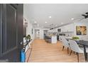 Open-concept living space with modern furnishings, light wood floors, and a stylish dining area at 1928 Wildwood Dr, Decatur, GA 30032