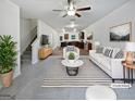Bright, staged living room with modern furniture, a ceiling fan, and a view of the kitchen at 4001 Avalon Sw Rd, Atlanta, GA 30331