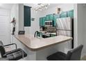 Modern kitchen with stainless steel appliances, custom cabinets, and breakfast bar seating at 2700 Pine Ne St # 2108, Atlanta, GA 30324