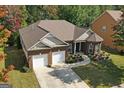 Aerial view of a brick home with a well-maintained lawn and a two-car garage at 4424 Bellwood Cir, Atlanta, GA 30349