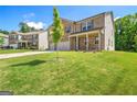 Two-story brick home with well-maintained lawn and young tree in front at 2715 Serena Way, Atlanta, GA 30331