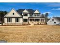 Two-story house with gray siding, stone accents, and a covered porch at 140 Dockside Dr # 381, Fayetteville, GA 30215