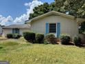 A single-story white brick home with light blue shutters and green bushes at 2071 Twin Falls Rd, Decatur, GA 30032
