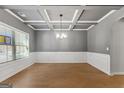 Elegant dining room with wainscoting, coffered ceiling, and hardwood floors at 527 Bohannon Rd # 12, Grantville, GA 30220