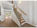 Bright foyer with a staircase featuring wood treads and black metal balusters at 527 Bohannon Rd # 12, Grantville, GA 30220