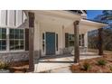 Inviting front porch with stone accents and wood pillars highlighting the home's entrance at 515 Bohannon Rd # 13, Grantville, GA 30220
