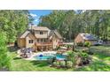 Aerial view of house, pool, detached garage and expansive backyard at 140 Haddock Pt, Brooks, GA 30205
