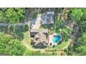 Aerial view of house, detached garage, and large lot with a circular driveway at 140 Haddock Pt, Brooks, GA 30205