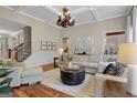 Spacious living room featuring hardwood floors, neutral decor, and a cozy seating area at 140 Haddock Pt, Brooks, GA 30205
