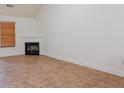 Bright living room with a cozy fireplace, window with blinds, and tile flooring at 516 Jaclyn Cir, Mcdonough, GA 30253