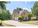 Brick house with a three-car garage and a long driveway at 185 Fieldstone Way, Fayetteville, GA 30215