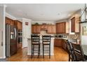 Kitchen with an island, wood cabinets, and stainless steel appliances at 185 Fieldstone Way, Fayetteville, GA 30215