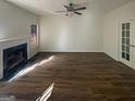 Open living room with fireplace, ceiling fan, wood flooring and lots of natural light at 200 Eagle Glen Ct, Woodstock, GA 30189