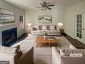Bright living room with fireplace, neutral colors, ceiling fan, and lots of natural light at 200 Eagle Glen Ct, Woodstock, GA 30189