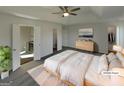 Primary bedroom featuring a tray ceiling, ceiling fan, ensuite bath, and walk-in closet at 200 Eagle Glen Ct, Woodstock, GA 30189