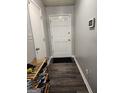 Clean hallway with gray walls and wood-look flooring at 9388 Crest Knoll Ct, Jonesboro, GA 30238