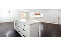 Bright kitchen island with white cabinets, quartz countertops, and black hardware in open layout at 504 Milligan Dr, Stone Mountain, GA 30083