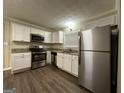Updated kitchen featuring stainless steel appliances, granite countertops, and white cabinets at 3086 Meadow Lark Ln, East Point, GA 30344
