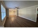 Spacious living room with hardwood floors, neutral walls, ceiling fan, and natural light from window at 3086 Meadow Lark Ln, East Point, GA 30344
