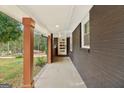 Charming front porch of a home, showing brick and dark brown painted wood at 1973 Glendale Dr, Decatur, GA 30032