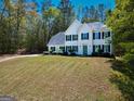 Lovely two-story home with a well-maintained lawn and a charming front facade surrounded by trees at 22 Agean Way, Whitesburg, GA 30185