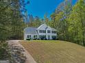 Charming two-story home with black shutters, complemented by a well-manicured lawn and driveway at 22 Agean Way, Whitesburg, GA 30185