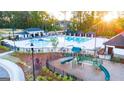 Community pool and playground with surrounding homes and landscaping at 311 Aspen Valley Drive, Loganville, GA 30052