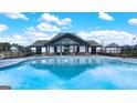 Community pool with a clubhouse and plenty of seating at 311 Aspen Valley Drive, Loganville, GA 30052