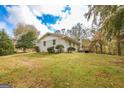 Expansive backyard view showcasing a well-maintained lawn and mature trees at 105 Tranquility Dr, Villa Rica, GA 30180