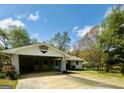 Bright exterior view showcasing the home's carport and neat landscaping against a blue sky at 105 Tranquility Dr, Villa Rica, GA 30180