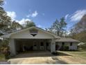 Front exterior with carport featuring brick support and neutral paint, complemented by well-maintained grounds at 105 Tranquility Dr, Villa Rica, GA 30180
